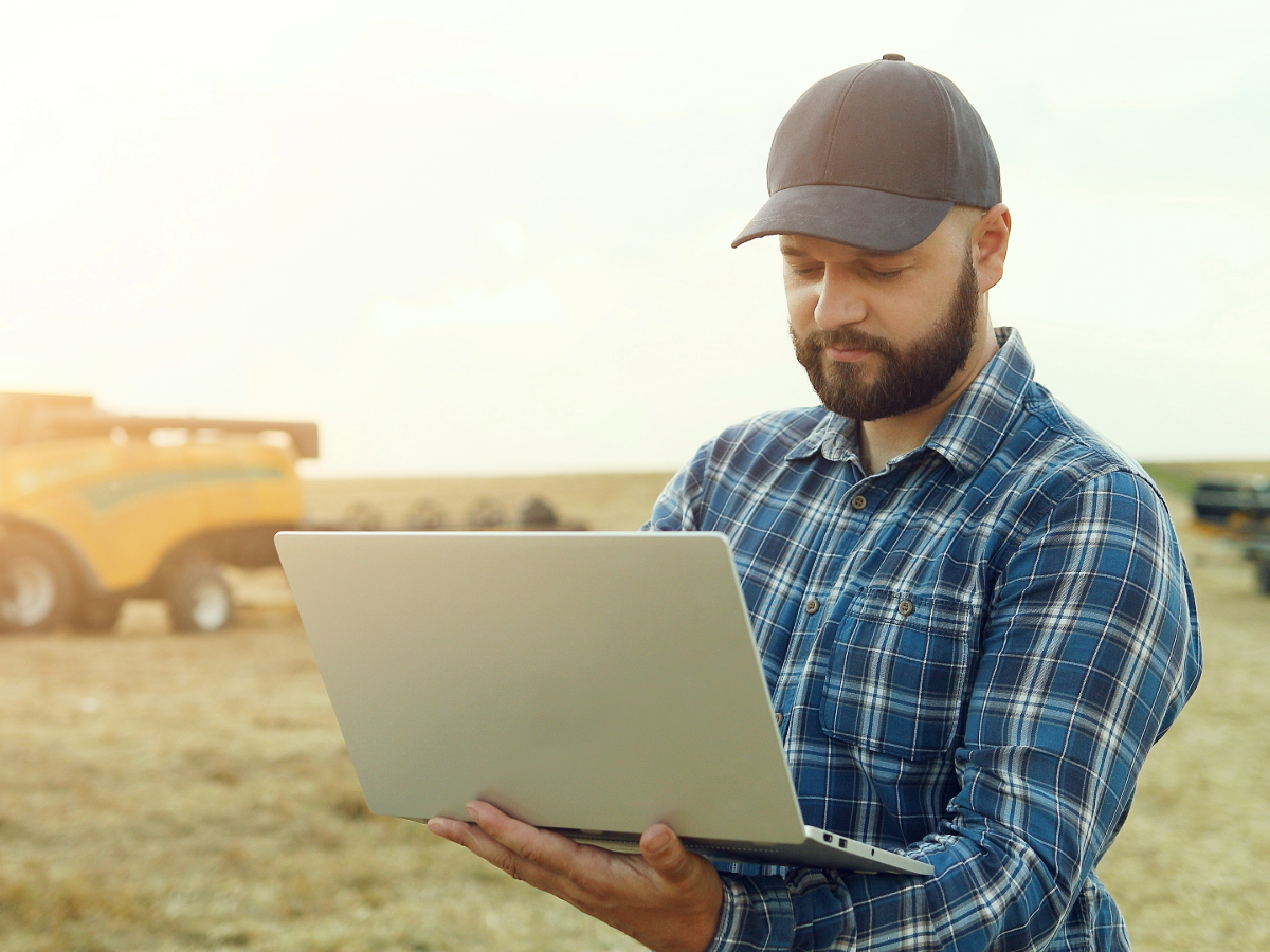 Man with laptop on the field