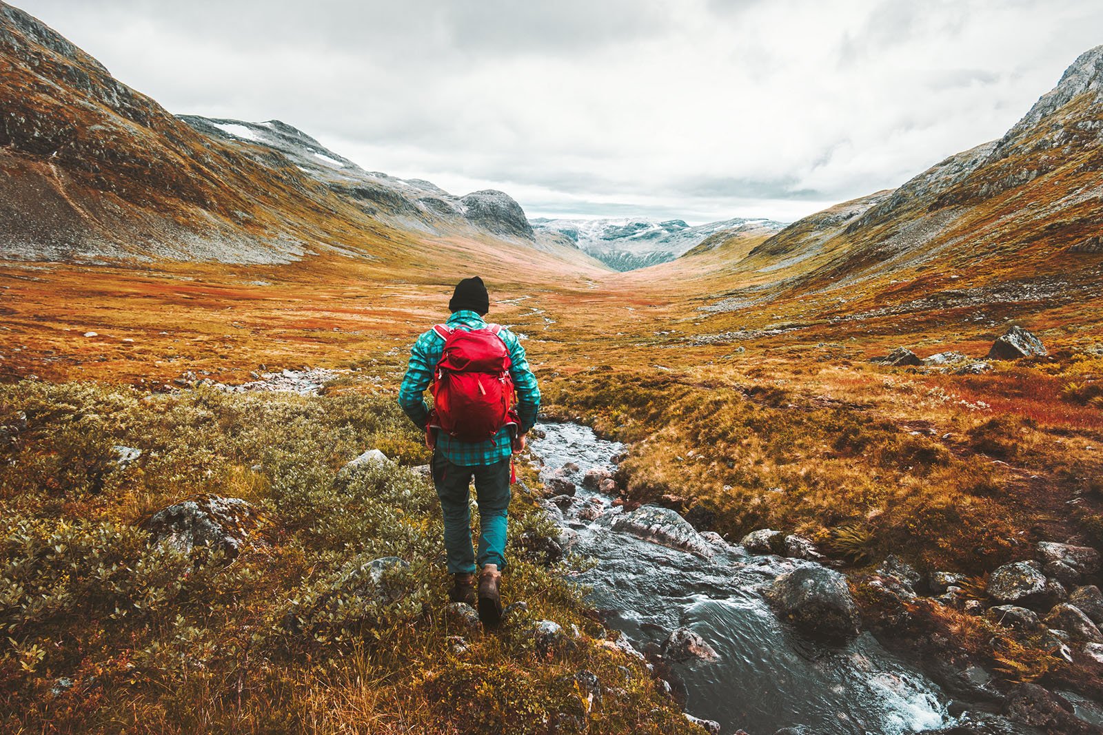 Man-crossing-the-river-web-iStock-1263368826